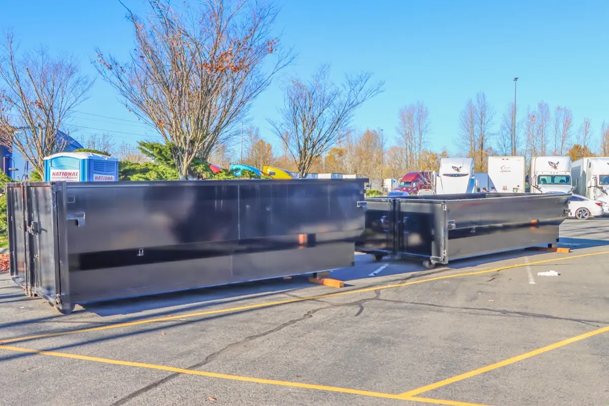 Professional dumpster rental service with roll-off container on residential driveway in Federal Way
